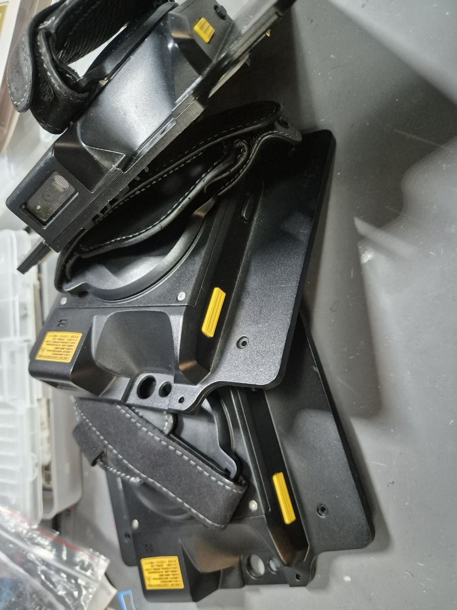 Zebra ZBK-ET5X-8SCN scanner expansion backs with hand straps on the repair bench