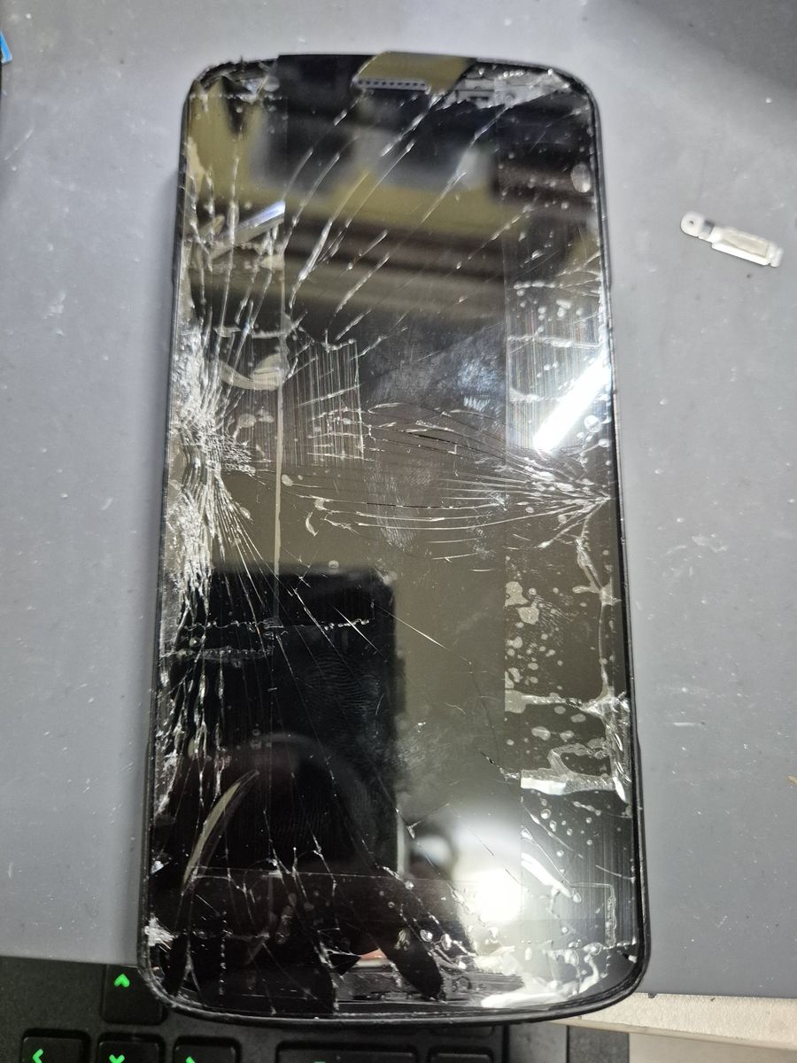 Zebra TC27 handheld computer with a badly shattered screen before repair